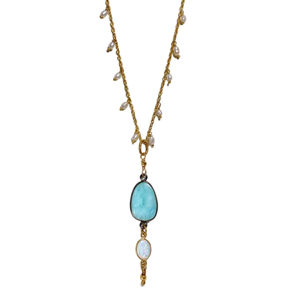 This handcrafted necklace by self-proclaimed California dreamer Robindira Unsworth, features a bright larimar and Australian opal pendant on a vermeil chain dotted with pearls. Larimar is commonly believed to be a calming stone, offering stillness, serenity, and all the cooling vibes you could ever wish for. Available at Shaylula Jewlery & Gifts in Tarrytown, NY and online. • Larimar, Australian opal, fresh water pearl, 22k gold vermeil, sterling silver • 18" L • Shepard hook