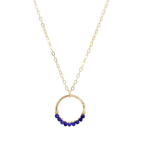 Sonya Renee Full Circle Necklace & Earring Set - Available at Shaylula Jewlery & Gifts in Tarrytown, NY and online. This Shaylula Exclusive set is comprised of the ever favorite Full Circle Necklace & Earrings, and is one of our best sellers! Bright Lapis beads are wire wrapped around a hammered gold filled frame and hangs from a delicate chain. Even prettier with the matching earrings, they make a fabulous gift for any one in your circle of friends. • Lapis, 14k gold filled
