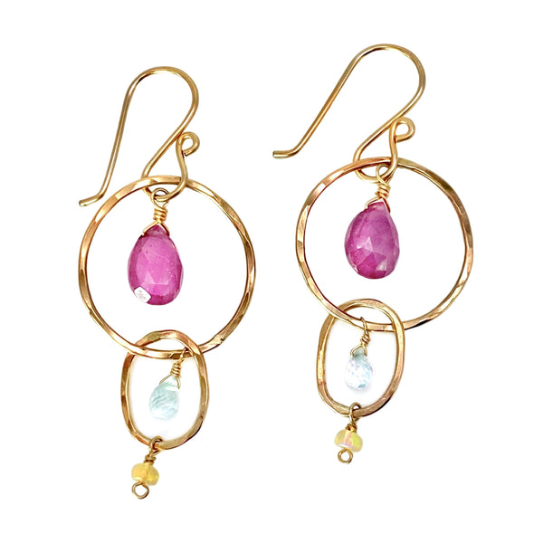 Vannucci Ruby Hoop Earrings - Available at Shaylula Jewlery & Gifts in Tarrytown, NY and online.  These cheerfully colored hoop earrings will brighten up any ensemble! Rubies, aquamarines and opals dangle from hammered 14k gold filled hoops.  • Ruby, aquamarine, opal, 14k gold filled  • 1.75" L  • 14k gold fill earwire