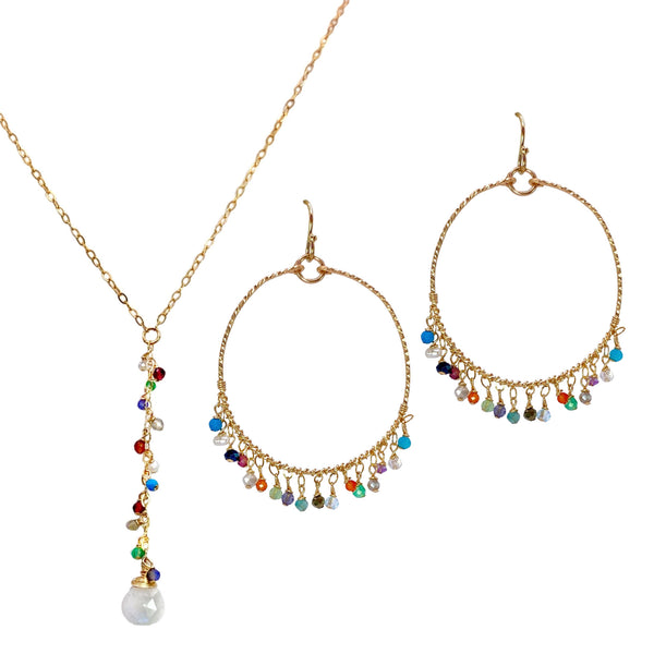 Sonya Renee Y Not Necklace & Earring Set - Available at Shaylula Jewlery & Gifts in Tarrytown, NY and online. This Shaylula Exclusive set is comprised of the ever favorite Y Not Necklace & Fiesta Hoops and is one of our best sellers! The simple necklace features multi-colored gemstone droplets on a thin cable chain. The delicate, featherweight hoops have a clustered fringe of semi-precious stones and look beautiful on everyone. Very shimmery! • Semi-precious stones, 14k gold filled