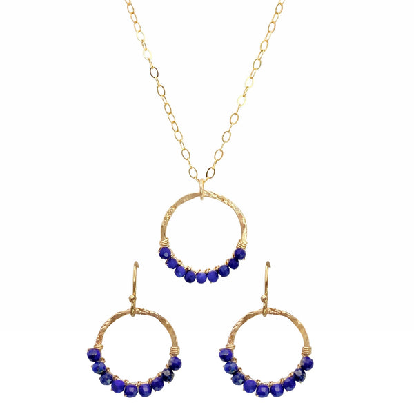 Sonya Renee Full Circle Necklace & Earring Set - Available at Shaylula Jewlery & Gifts in Tarrytown, NY and online. This Shaylula Exclusive set is comprised of the ever favorite Full Circle Necklace & Earrings, and is one of our best sellers! Bright Lapis beads are wire wrapped around a hammered gold filled frame and hangs from a delicate chain. Even prettier with the matching earrings, they make a fabulous gift for any one in your circle of friends. • Lapis, 14k gold filled