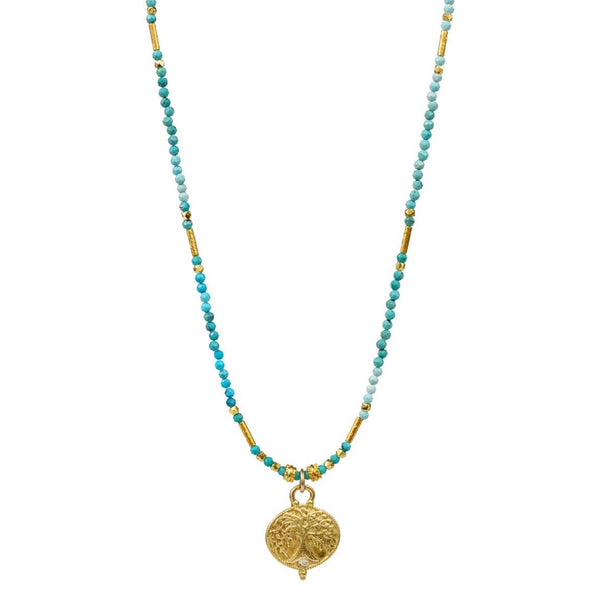 Lulu Designs Raina Necklace - Available at Shaylula Jewlery & Gifts in Tarrytown, NY and online. Raina is all about ethereal sparkle... A cast yellow bronze Gaia pendant accented with a diamond hangs from a strand of micro-faceted turquoise gemstones, interspersed by gold vermeil accents. Gaia was the goddess of earth and represents universal connection. Made with love in Mill Valley, CA.  • Turquoise, diamond, yellow bronze, 18k gold vermeil  • 16 - 18" L adjustable; Lobster clasp  • .55" diameter pendant