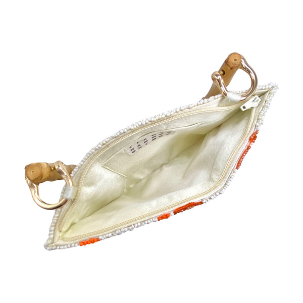 Tiana NY Love for Oranges Beaded Bag available at Shaylula Jewlery & Gifts in Tarrytown, NY and online.This cheery handmade beaded bag is petite but is still big enough to hold all your essentials and it has a zipper closure to keep everything safe! It features a bamboo handle and a satin lining with a small interior pocket. • 8.5" W x 6" H