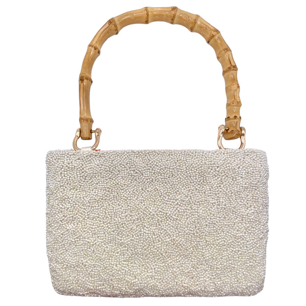 Tiana NY Love for Oranges Beaded Bag available at Shaylula Jewlery & Gifts in Tarrytown, NY and online.This cheery handmade beaded bag is petite but is still big enough to hold all your essentials and it has a zipper closure to keep everything safe! It features a bamboo handle and a satin lining with a small interior pocket. • 8.5" W x 6" H