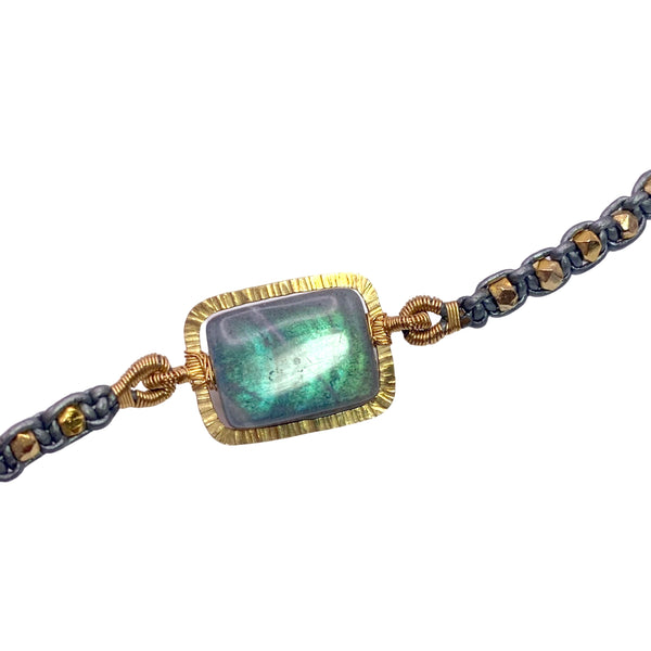 Dana Kellin Labradorite & Leather Bracelet is available at Shaylula Jewlery & Gifts in Tarrytown, NY and online. This flashy, cabochon labradorite is surrounded by a textured gold frame showcasing its incredible color. The bracelet is finished with gold nuggets woven in leather and a toggle clasp. • 14k gold filled, labradorite, leather  • 7" L  • Toggle clasp