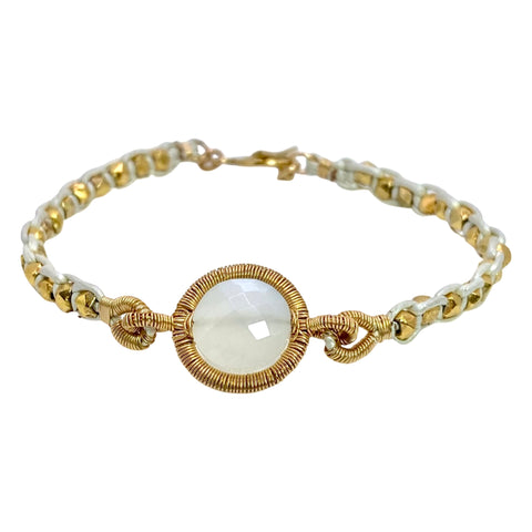 Dana Kellin Moonstone & Leather Bracelett is available at Shaylula Jewlery & Gifts in Tarrytown, NY and online. This milky, faceted moonstone is intricately wire wrapped, creating a golden halo. The bracelet is finished with gold nuggets woven in leather and a toggle clasp. • 14k gold filled, moonstone, leather • 7" L • Toggle clasp