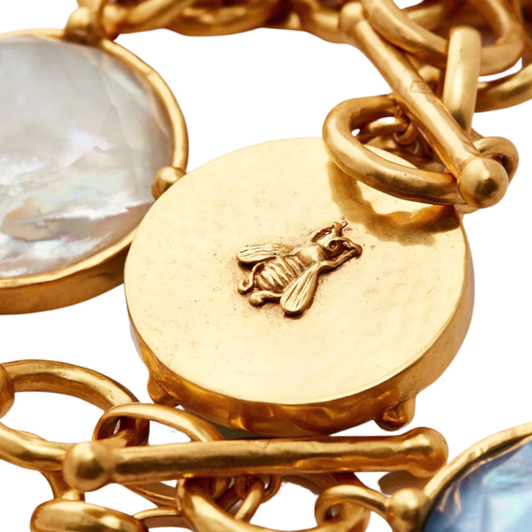 Julie Vos Honeybee Statement Necklace Available at Shaylula Jewlery & Gifts in Tarrytown, NY and online.Faceted sparkling imported glass with mother of pearl doublet on a lightly hammered link, finished with a front toggle closure. Cameo bee on reverse side. (Shown in white for scale) • 24K gold plate, imported glass, mother of pearl • 19" L