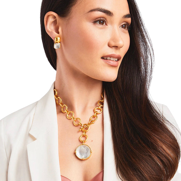 Julie Vos Honeybee Statement Necklace Available at Shaylula Jewlery & Gifts in Tarrytown, NY and online.Faceted sparkling imported glass with mother of pearl doublet on a lightly hammered link, finished with a front toggle closure. Cameo bee on reverse side. (Shown in white for scale) • 24K gold plate, imported glass, mother of pearl • 19" L