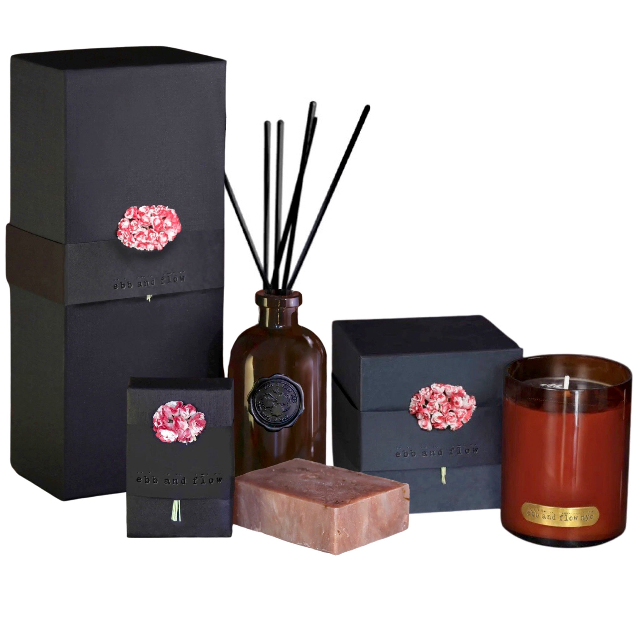 Ebb + Flow NYC Tobacco Black Cherry Fragrance Gift Set available at Shaylula Jewlery & Gifts in Tarrytown, NY and online. Gift Set includes a reed diffuser that will last up to 1 year, a soy candle in a mouth-blown glass with a 65 hour burn time and an olive oil based soap with plant-based essential oils. All are packaged in beautiful recycled material with hand-dyed paper flowers.  Hypoallergenic and vegan.
