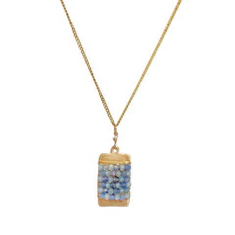 Michelle Pressler Opal & Sapphire ID Tag Necklace - Available at Shaylula Jewlery & Gifts in Tarrytown, NY and online.Beautiful opal and sapphire beads are wrapped on a simple brushed gold ID tag which hangs on a smooth curb chain, accented with a tiny freshwater pearl.   • Opal, sapphire, 14k gold filled • 17" L chain, .75" L x .5" W pendant • Lobster clasp
