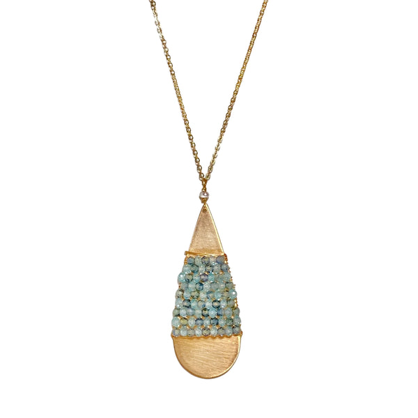 Michelle Pressler Beautiful natural blue zircon and Australian sapphire beads are wrapped on a simple brushed gold teardrop which hangs on a delicate long chain accented with a tiny freshwater pearl.  • Australian sapphire, natural blue zircon, 14k gold filled  • 30" L chain, 2.5” L x.625” W pendant  • Lobster clasp