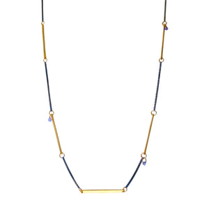   This necklace is effortlessly cool and edgy. Oxidized silver chain is mixed with matte gold bars and accented with iolite briolettes. It goes with all you other jewelry and makes a great layering piece, as shown in the secondary pictures.  Lulu Designs uses the finest, sustainably sourced metals and precious gemstones in all their jewelry. Made in Mill Valley, California with love!  • Oxidized sterling silver, iolite, 14k gold filled  • 16" L  • Lobster clasp