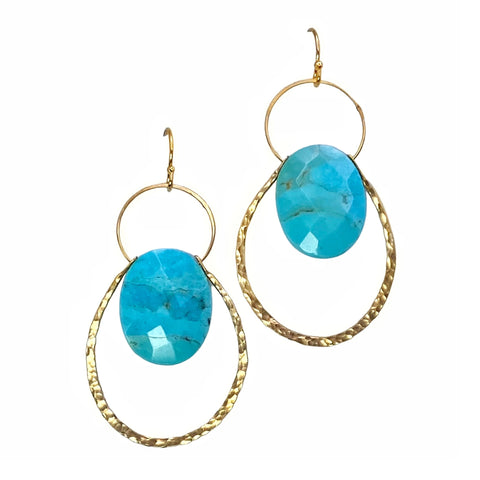 Lulu Designs Cali Earrings - Available at Shaylula Jewlery & Gifts in Tarrytown, NY and online.   A dramatic faceted turquoise oval gemstone floats in the center of two intersecting hammered gold hoops making them a refreshing statement earring that goes with everything! Made with love in Mill Valley, CA. (Model is wearing labradorite version.)  • Turquoise, 14k gold filled  • 1.75" L;  .71" L x  .51" W turquoise  • 14k gold fill earwire