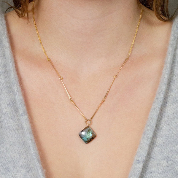 Lulu Designs Vida Necklace - Available at Shaylula Jewlery & Gifts in Tarrytown, NY and online. A faceted cushion-cut turquoise gem swings from hammered 14k gold filled links, making a striking piece. Made with love in Mill Valley, CA. (model is wearing labradorite version)  • Turquoise, 14k gold filled, 18k gold vermeil   • 18 - 20" L adjustable; Lobster clasp  • .79" diameter pendant