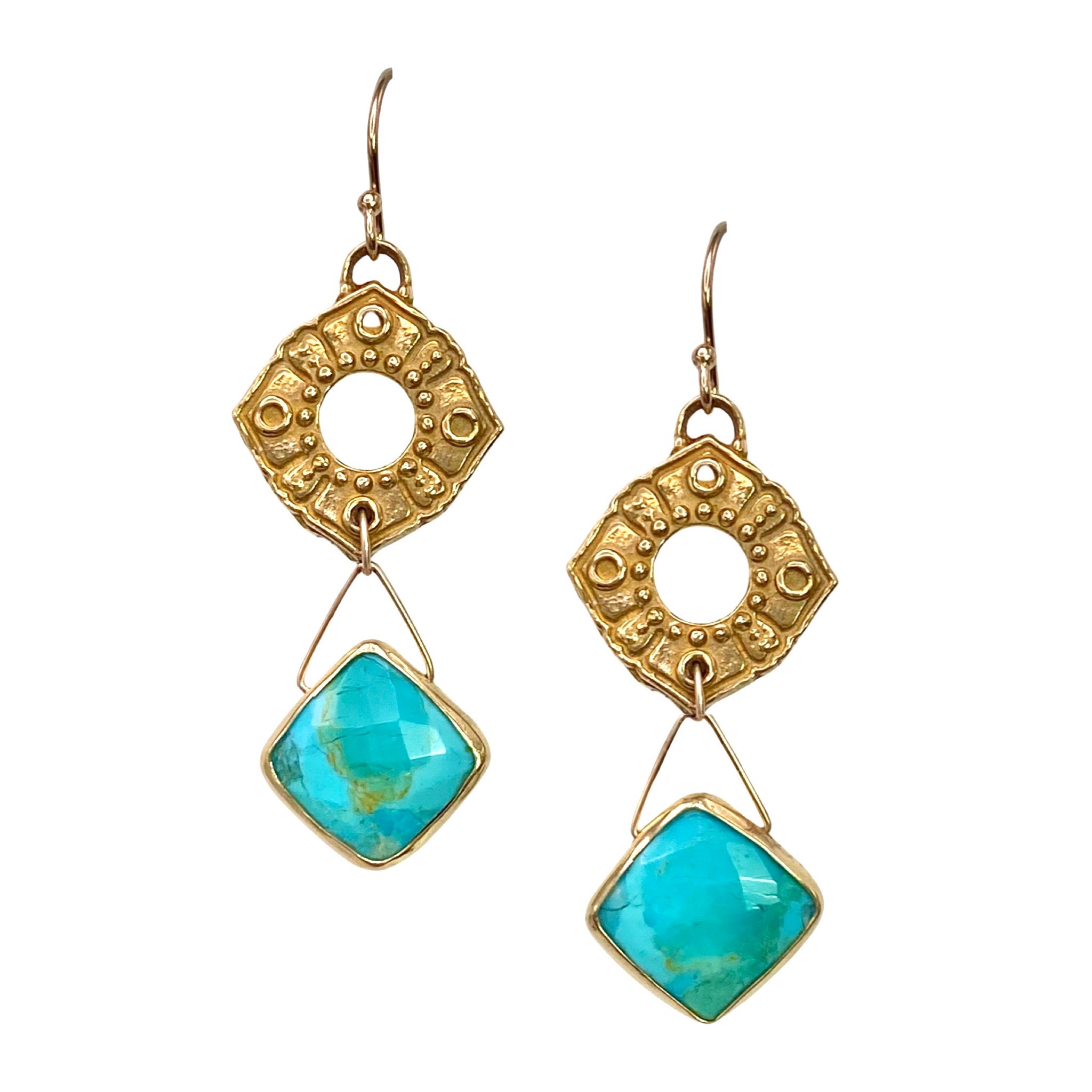 Lulu Designs Poppy Earrings - Available at Shaylula Jewlery & Gifts in Tarrytown, NY and online. Lulu lovers get the royal treatment with these Poppy earrings - a hand-cast yellow bronze Anahata (also known as the heart chakra) charm gives way to cushion cut turquoise gem edged in 18k gold vermeil. Made with love in Mill Valley, CA. (Model is wearing moonstone version.)  • Turquoise, yellow bronze, 14k gold filled  • 1.75" L  • .67" Dia. casting; 51" Dia. turquoise  • 14k gold fill earwire
