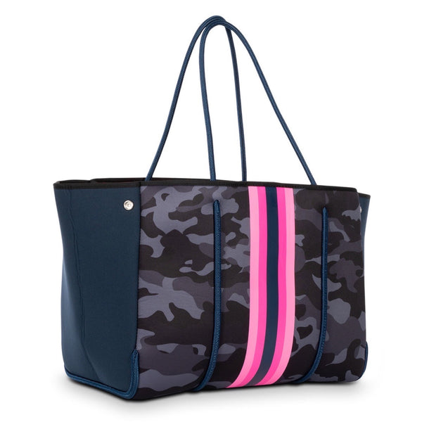 Haute Shore Greyson Epic Camo Tote Bag available at Shaylula Jewlery & Gifts in Tarrytown, NY and online. The Greyson is our favorite everyday tote. Designed to last, this neoprene tote is the perfect blend of luxury, style and functionality to take on the go! Think of it as the funky, vegan, little sister to LV's Neverfull... It even includes a removable zipper pouch.  • Neoprene  • Bag - 18" W x  12" H x 10" D; Strap - 10.25"; Pouch - 8.5" W x 6" H