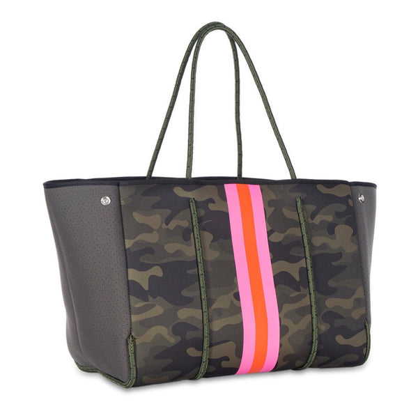 Haute Shore Greyson Showoff Camo Tote Bag available at Shaylula Jewlery & Gifts in Tarrytown, NY and online. The Greyson is our favorite everyday tote. Designed to last, this neoprene tote is the perfect blend of luxury, style and functionality to take on the go! Think of it as the funky, vegan, little sister to LV's Neverfull... It even includes a removable zipper pouch.  • Neoprene  • Bag - 18" W x  12" H x 10" D; Strap - 10.25"; Pouch - 8.5" W x 6" H