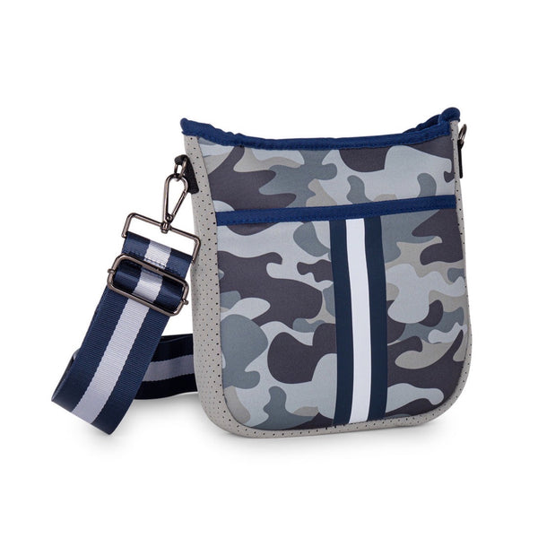 Haute Shore Jeri Refresh Crossbody available at Shaylula Jewlery & Gifts in Tarrytown, NY and online. Looking for a small sized crossbody that will hold all your essentials while still remaining stylish? The Jeri is the bag for you! Top zipper closure and hidden front zipper pocket for organization. It includes 2 adjustable straps for mixing & matching - navy with white stripes and solid navy.  • Neoprene • Vegan friendly • 8.5" W x 2" D x 9.5" L