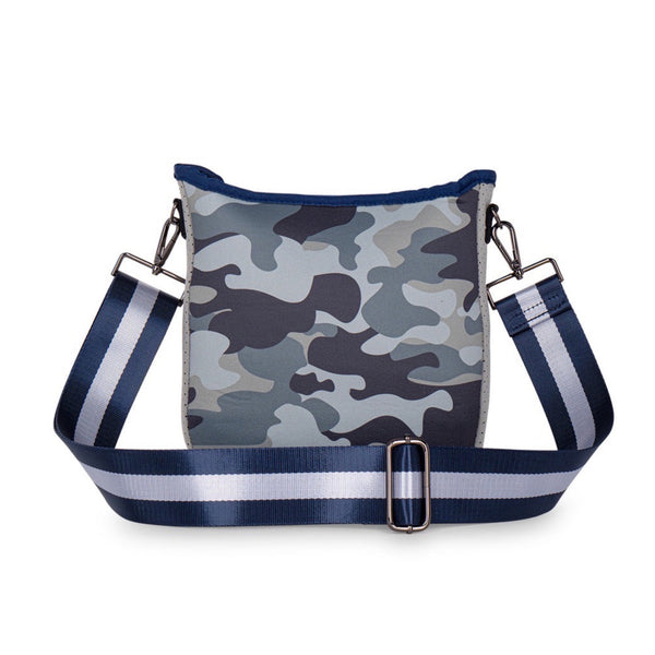 Haute Shore Jeri Refresh Crossbody available at Shaylula Jewlery & Gifts in Tarrytown, NY and online. Looking for a small sized crossbody that will hold all your essentials while still remaining stylish? The Jeri is the bag for you! Top zipper closure and hidden front zipper pocket for organization. It includes 2 adjustable straps for mixing & matching - navy with white stripes and solid navy.  • Neoprene • Vegan friendly • 8.5" W x 2" D x 9.5" L