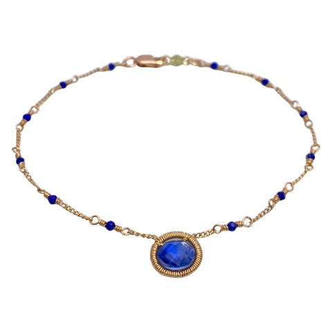 Dana Kellin Kyanite Bracelet is available at Shaylula Jewlery & Gifts in Tarrytown, NY and online. A faceted kyanite coin is the precision wrapped centerpiece of this delicate Dana Kellin bracelet that is accented with stations of lapis.  • 14k gold filled, kyanite, lapis  • 7" L 
