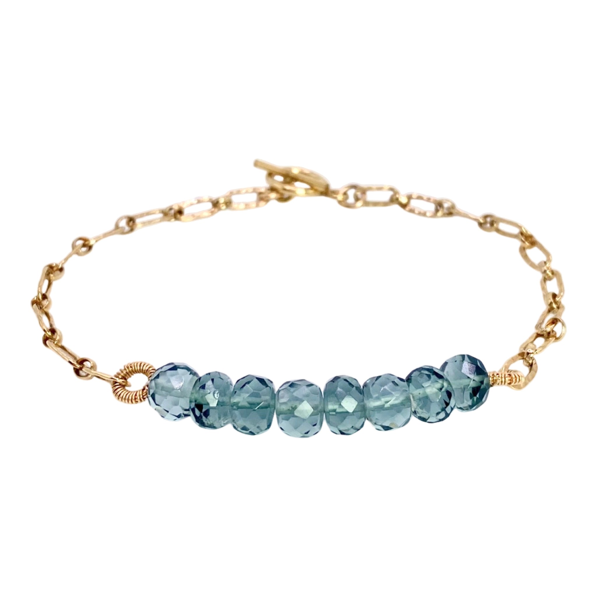 Dana Kellin Quartz Link Bracelet is available at Shaylula Jewlery & Gifts in Tarrytown, NY and online. Soft blue-grey, faceted rondelle quartz beads are mixed with hammered gold links in this fresh, modern, Dana Kellin bracelet. Layer it with more gold link bracelets for an arm party! • 14k gold filled, quartz • 7" L • Toggle clasp