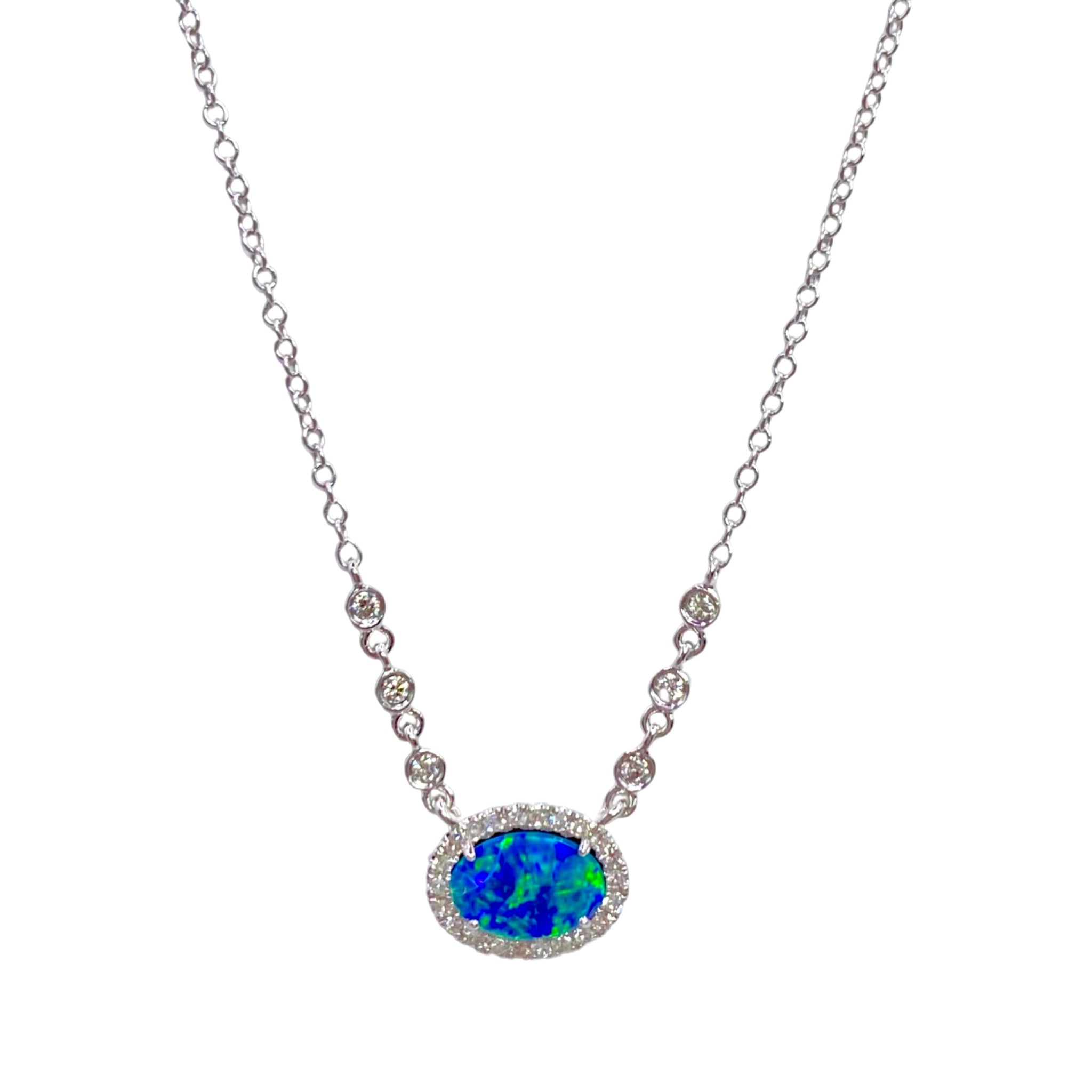 Meira T Opal & Diamond Necklace available at Shaylula Jewlery & Gifts in Tarrytown, NY and online. This beautiful blue opal pendant is surrounded by a halo of diamonds and has bright flashes of iridescent green. The pendant is flanked on both sides by three diamond stations on a white gold chain.  • 14k, .14 ct dia, .69 ct opal  • Lobster clasp