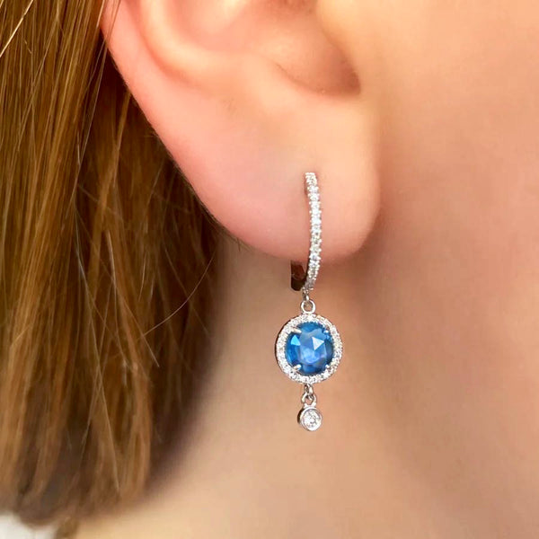 Dilamani Swiss Blue Topaz & Diamond Earrings Available at Shaylula Jewlery & Gifts in Tarrytown, NY and online. These stunning blue sapphire earrings are uniquely elegant! Crafted in 14k white gold and complemented with diamonds for extra sparkle.• 14k, .27 ct dia, 2.39 ct blue topaz