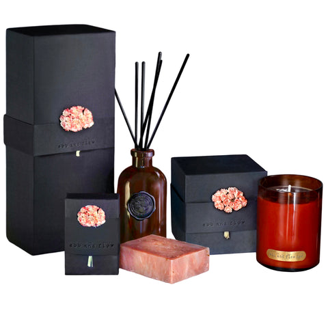 Ebb + Flow NYC Plumeria Fragrance Gift Set available at Shaylula Jewlery & Gifts in Tarrytown, NY and online. The Plumeria Fragrance Gift Set includes a reed diffuser that will last up to 1 year, a soy candle in a mouth-blown glass with a 65 hour burn time and an olive oil based soap with plant-based essential oils. All are packaged in beautiful recycled material with hand-dyed paper flowers. Hypoallergenic and vegan.